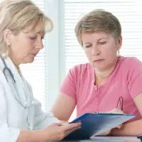 Woman having discussion with doctor